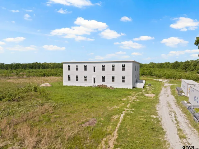 a view of a lake with table and chairs