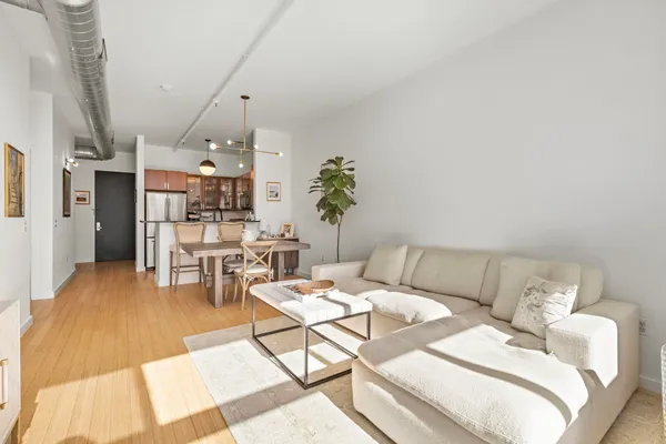 a living room with furniture and a chandelier