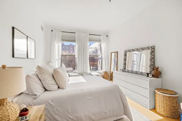 a spacious bedroom with a large bed and a large window