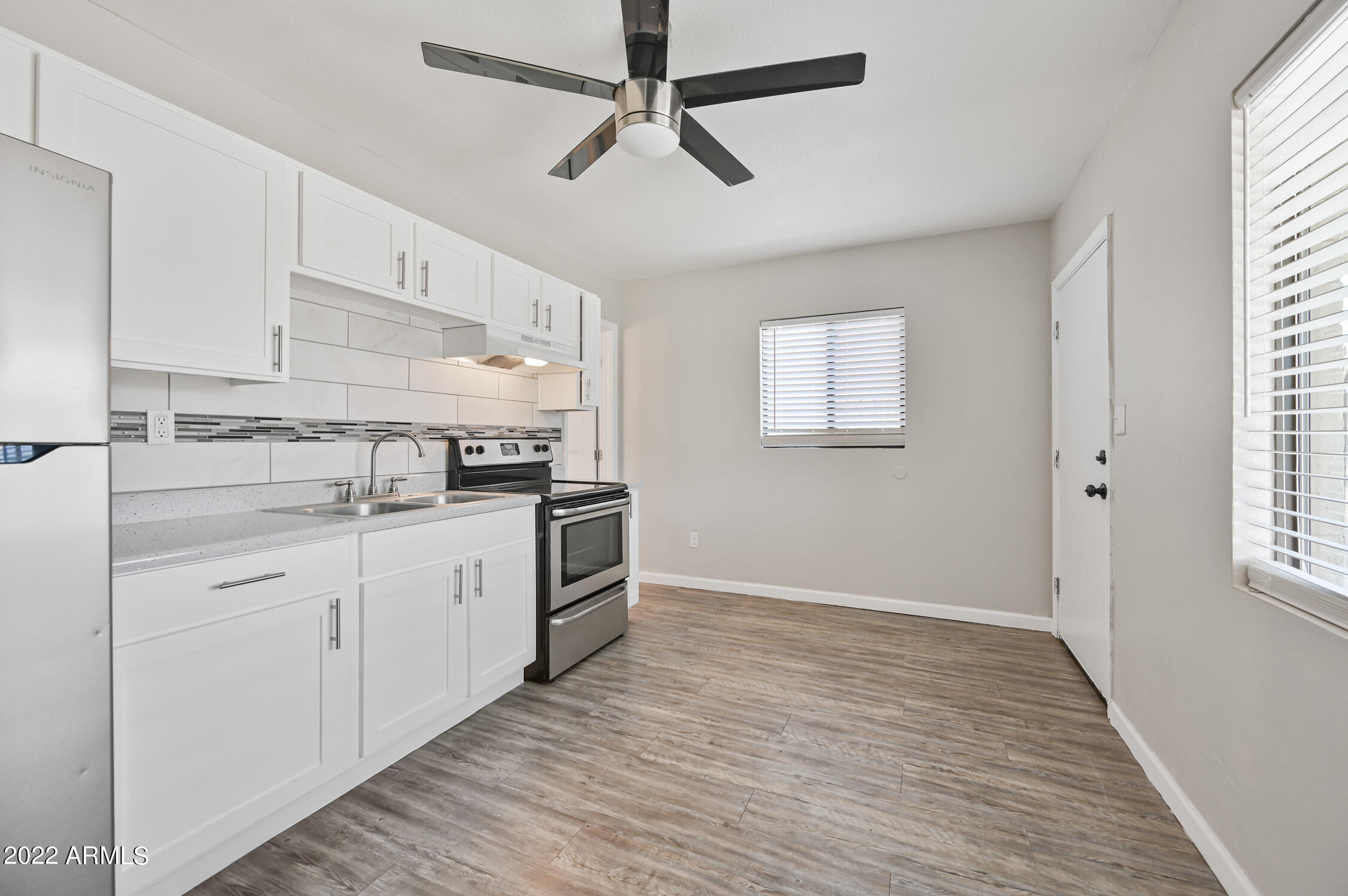 1744 West Glendale Avenue, Unit 1 Phoenix, AZ 85021 - Photo 6 of 12 a kitchen with granite countertop a sink cabinets stainless steel appliances and a window