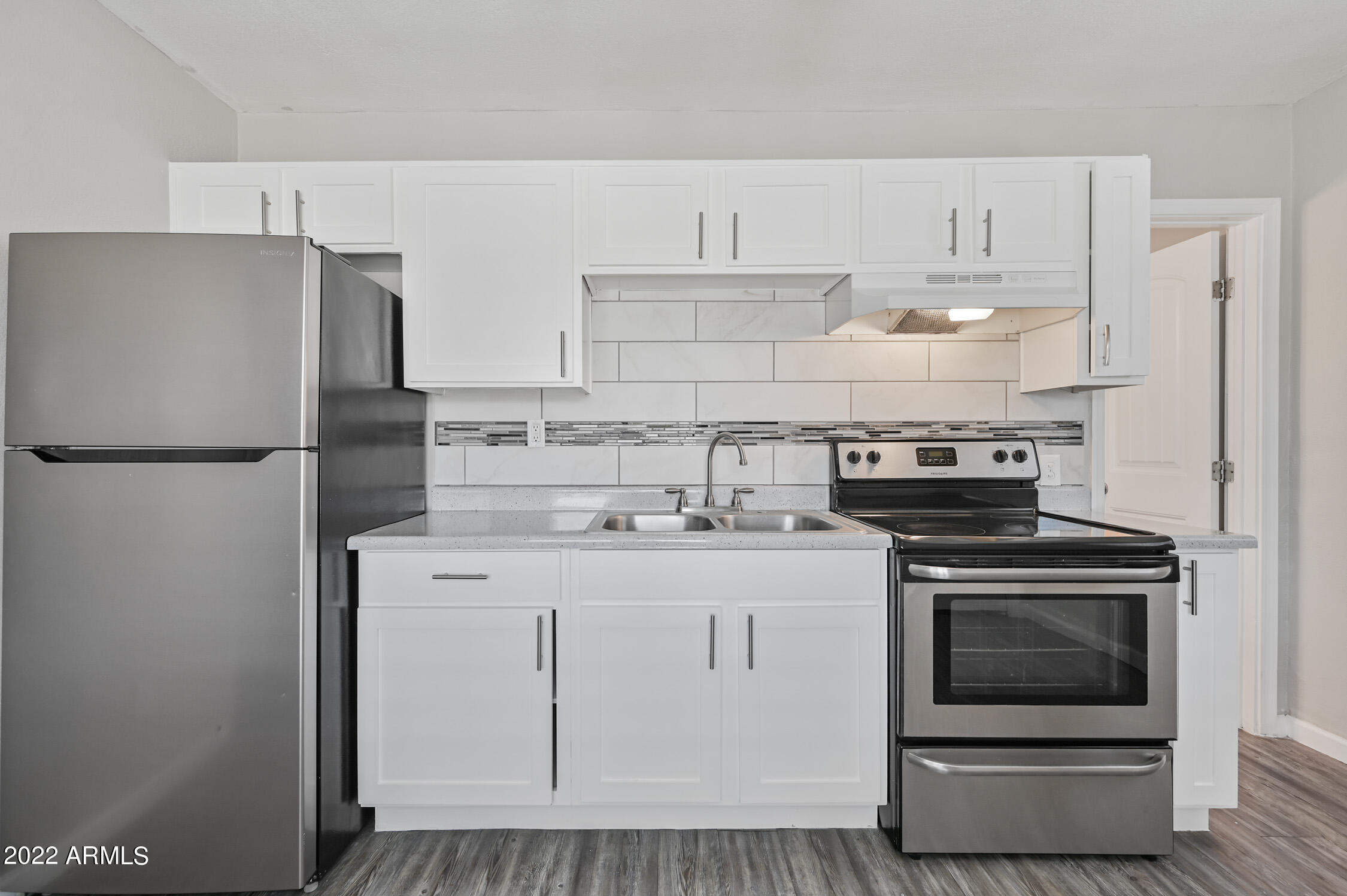 1744 West Glendale Avenue, Unit 1 Phoenix, AZ 85021 - Photo 7 of 12 a kitchen with a stove and a refrigerator