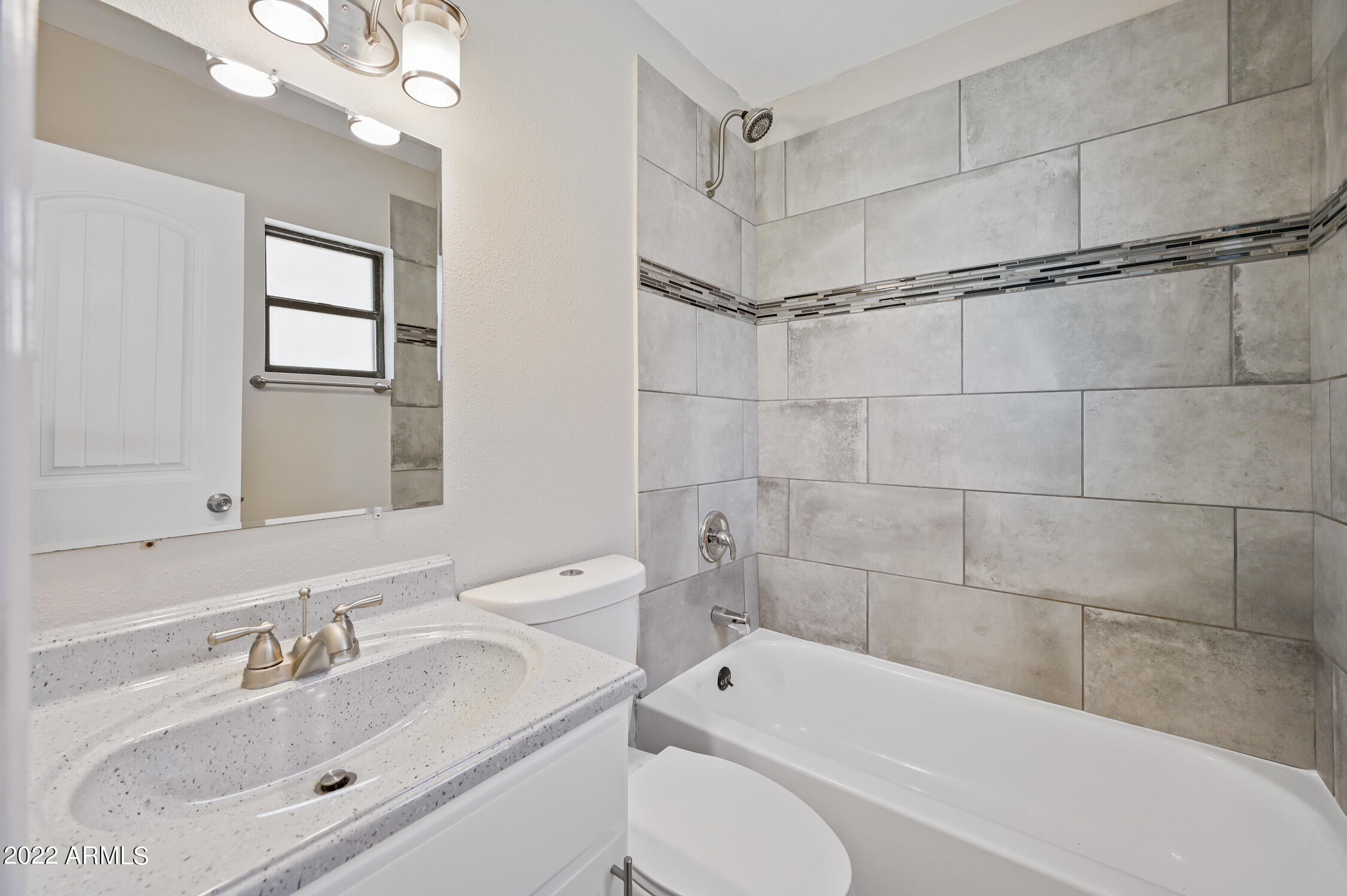 1744 West Glendale Avenue, Unit 1 Phoenix, AZ 85021 - Photo 8 of 12 a bathroom with a sink toilet and shower