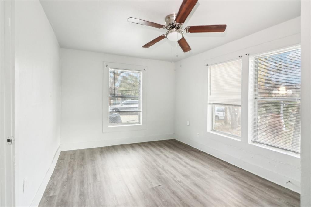 1906 Grainger Street Fort Worth, TX 76110 - Photo 12 of 38 Unfurnished room featuring light wood-type flooring and ceiling fan