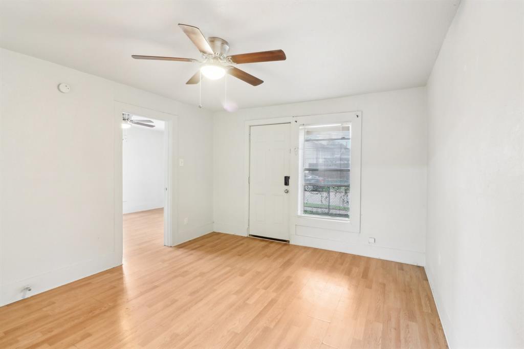 1906 Grainger Street Fort Worth, TX 76110 - Photo 17 of 38 Empty room with ceiling fan and light wood-type flooring