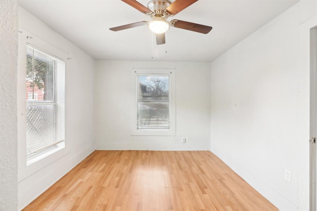1906 Grainger Street Fort Worth, TX 76110 - Photo 24 of 38 Empty room featuring ceiling fan and light wood-type flooring