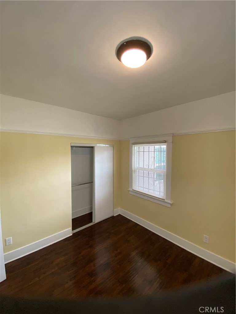 1331 Atlantic Avenue Long Beach, CA 90813 - Photo 17 of 44 an empty room with wooden floor and windows