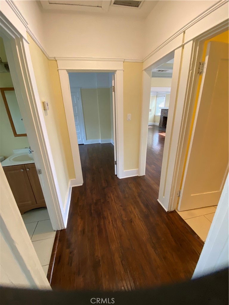 1331 Atlantic Avenue Long Beach, CA 90813 - Photo 18 of 44 a view of a hallway with wooden floor and stairs