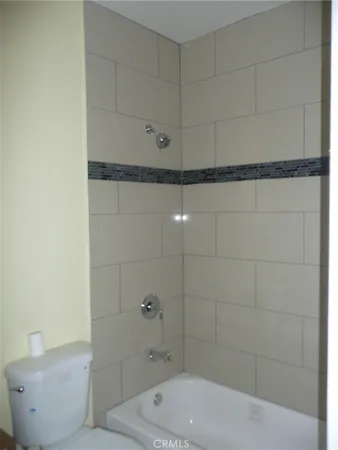 a bathroom with a bathtub and shower