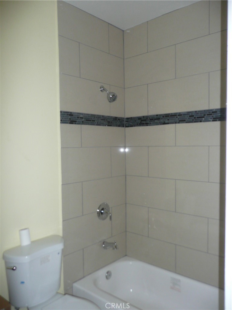 1331 Atlantic Avenue Long Beach, CA 90813 - Photo 20 of 44 a bathroom with a bathtub and shower