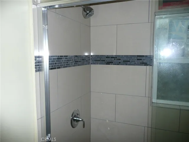 a bathroom with a shower and a mirror