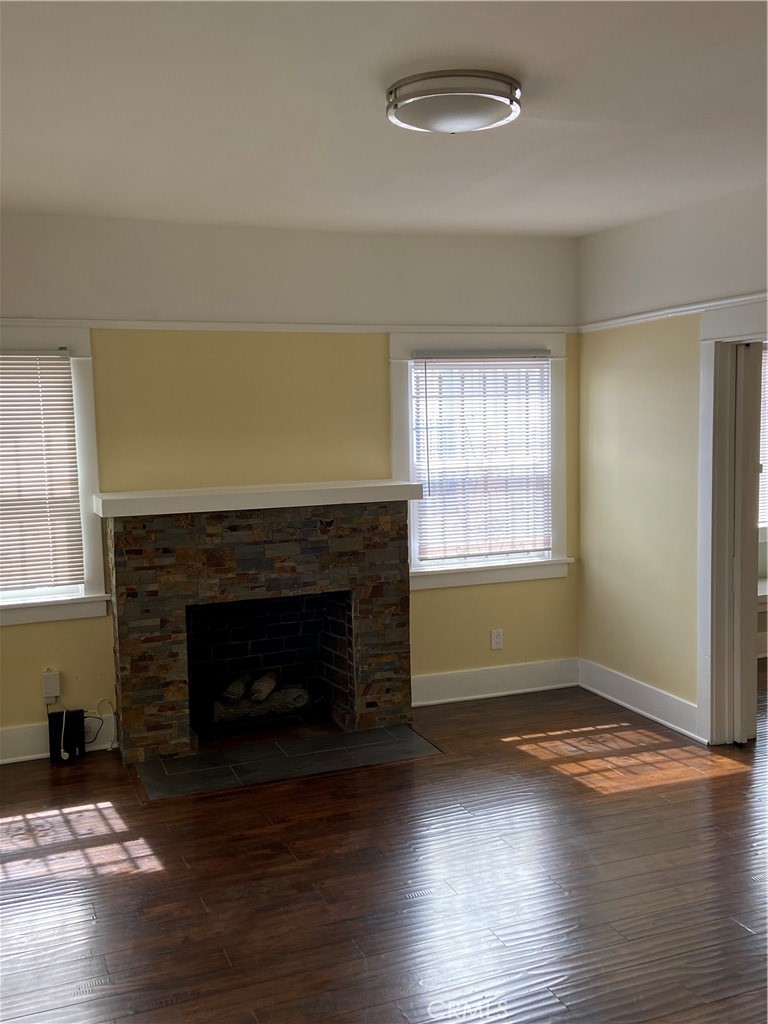 1331 Atlantic Avenue Long Beach, CA 90813 - Photo 30 of 44 an empty room with wooden floor fireplace and windows