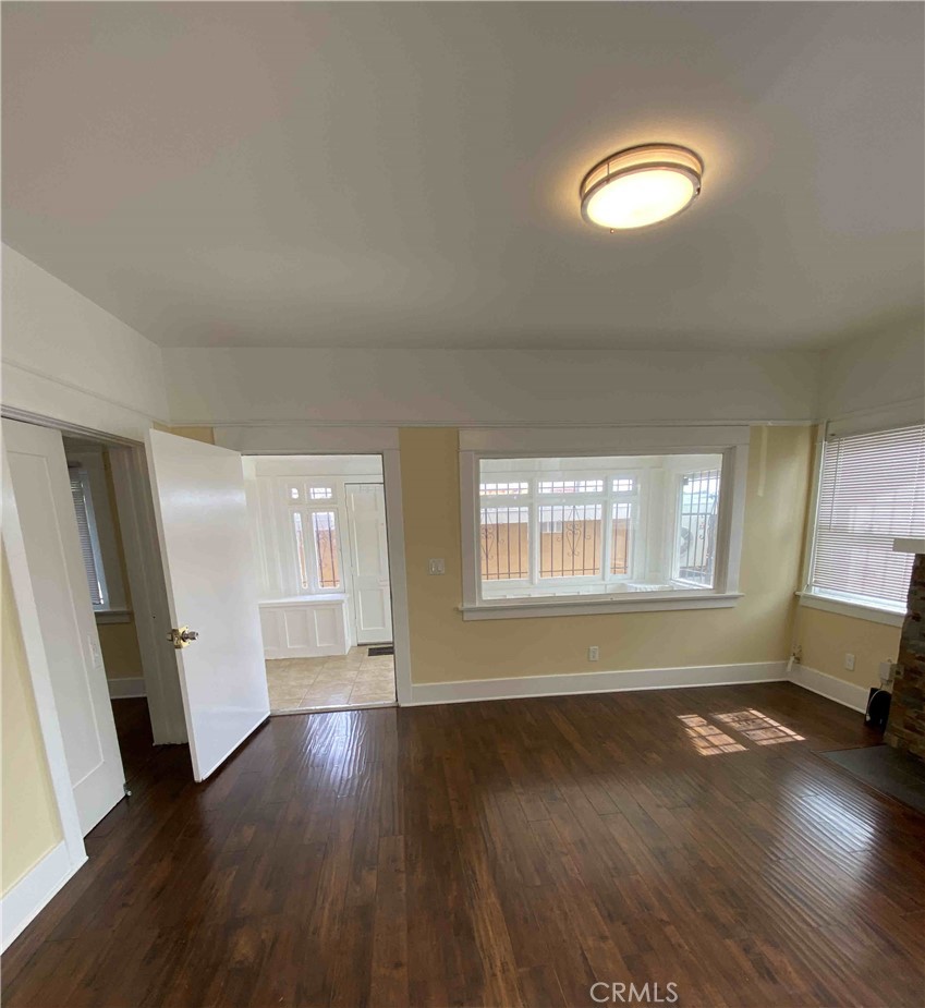 1331 Atlantic Avenue Long Beach, CA 90813 - Photo 34 of 44 an empty room with wooden floor and windows