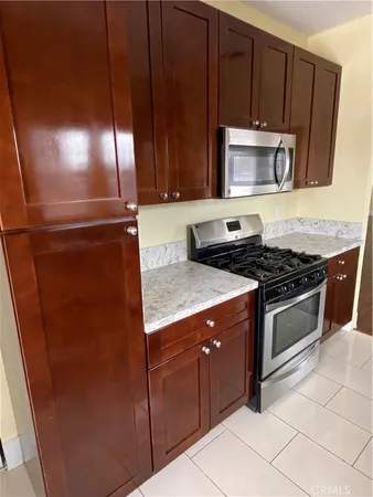 a kitchen with a stove microwave and sink