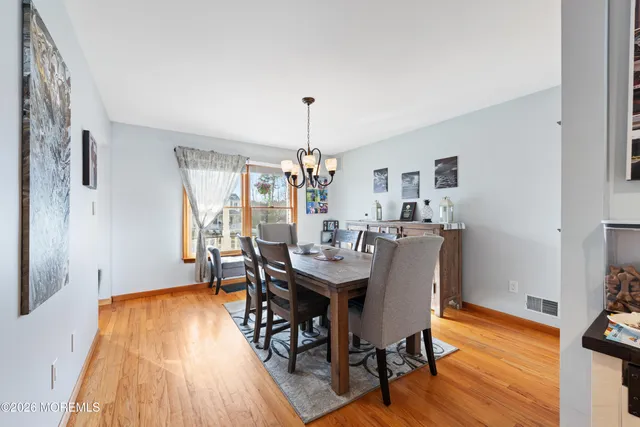 a dining room with furniture and wooden floor
