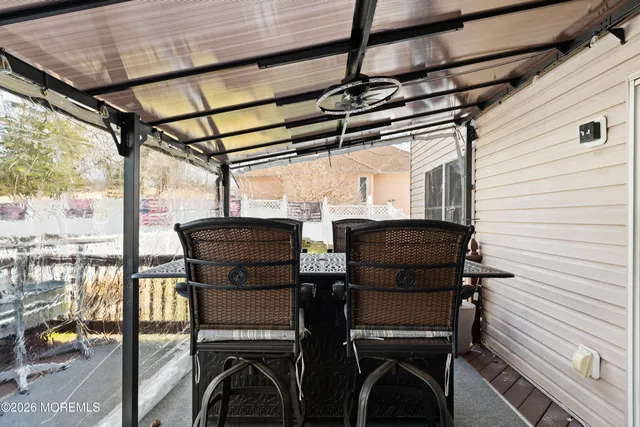 a view of a chairs and table in the balcony