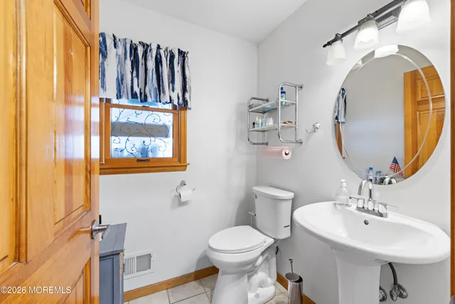 a bathroom with a sink mirror and toilet