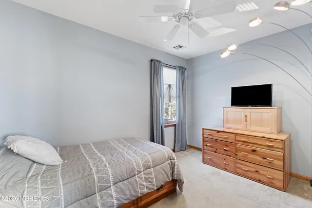 a bedroom with a bed and flat screen tv