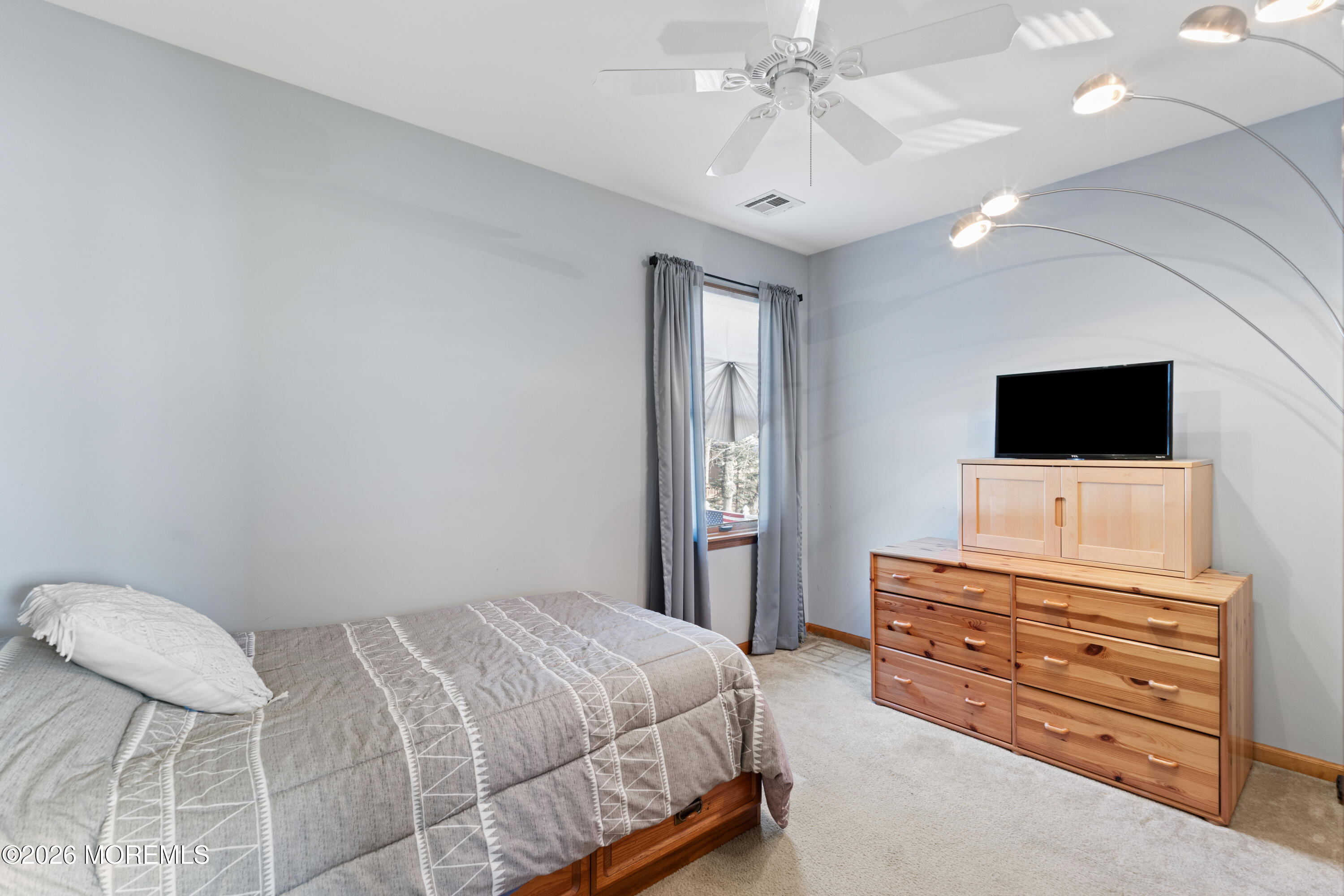 746 Rabbit Run Brick, NJ 08724 - Photo 22 of 41 a bedroom with a bed and flat screen tv