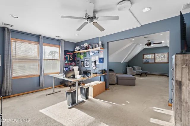 a living room with furniture a flat screen tv and a large window
