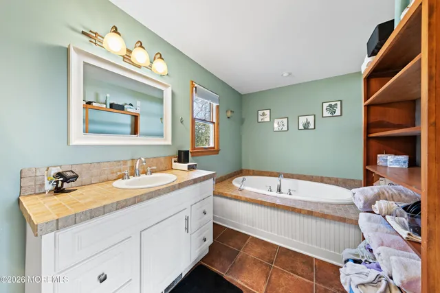 a bathroom with a sink double vanity and a bathtub