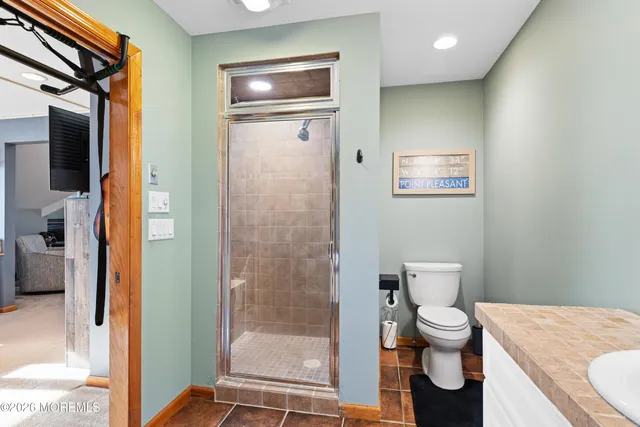 a bathroom with a toilet sink and shower