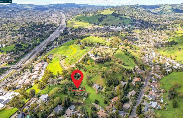 an aerial view of a houses with a yard