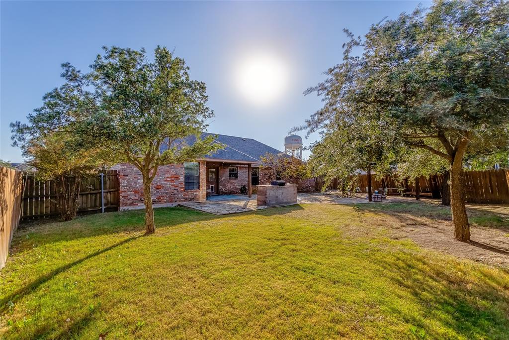 226 King George Road Ponder, TX 76259 - Photo 1 of 39 Rear view of house with a fenced backyard, a patio, brick siding, and roof with shingles