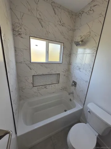 a bathroom with a toilet and a bathtub