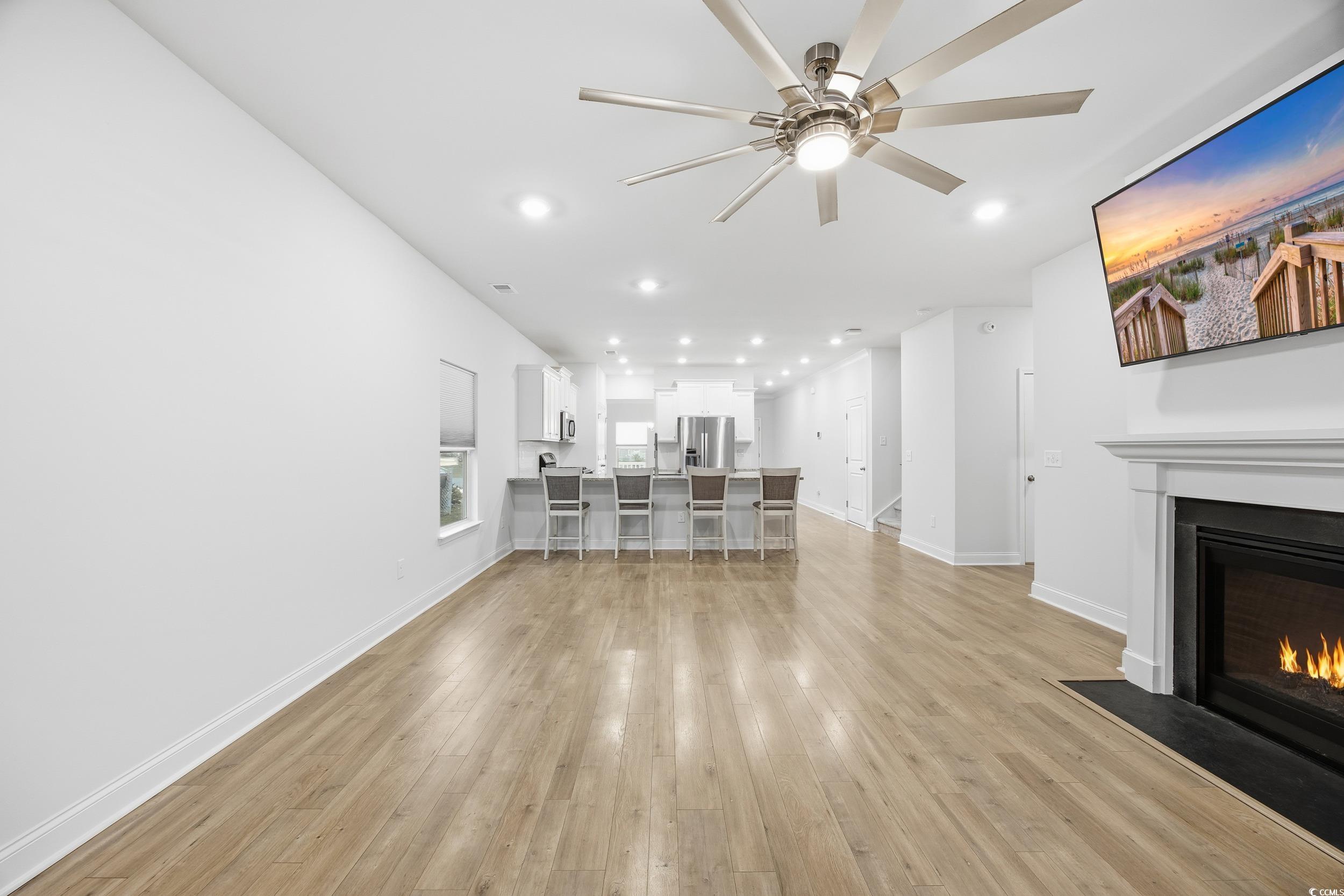 386 Harbison Circle Myrtle Beach, SC 29579 - Photo 14 of 34 Unfurnished living room with recessed lighting, light wood finished floors, a fireplace with flush hearth, and ceiling fan
