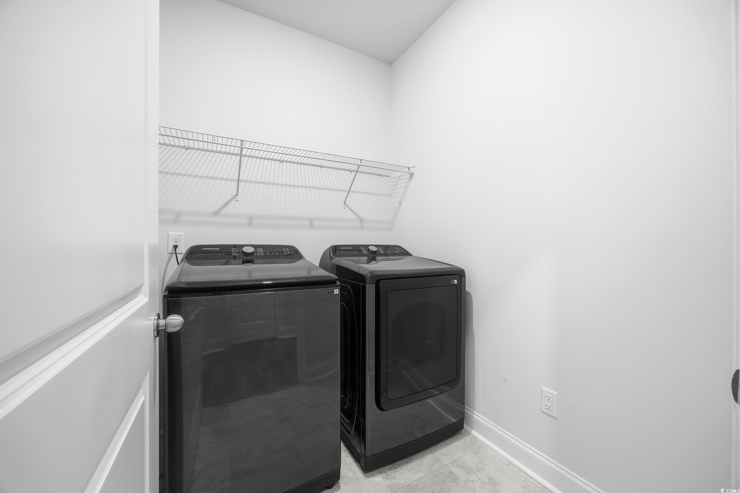 386 Harbison Circle Myrtle Beach, SC 29579 - Photo 17 of 34 Laundry room featuring washer and clothes dryer and light tile patterned floors