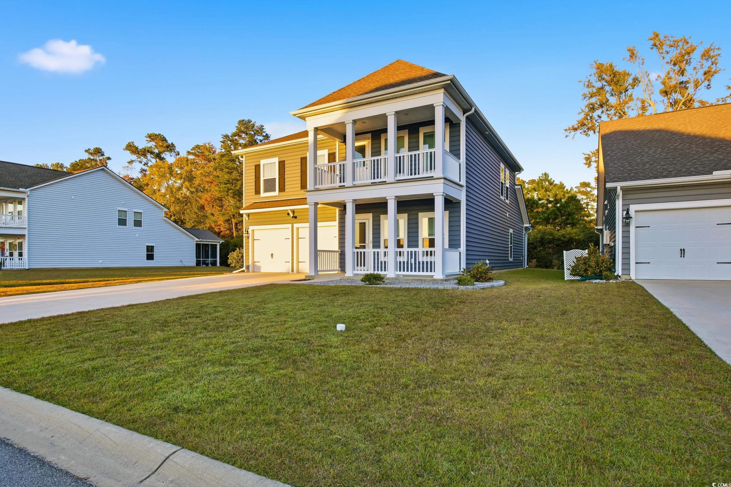 386 Harbison Circle Myrtle Beach, SC 29579 - Photo 2 of 34 View of front of property with a front yard, covered porch, driveway, and a garage