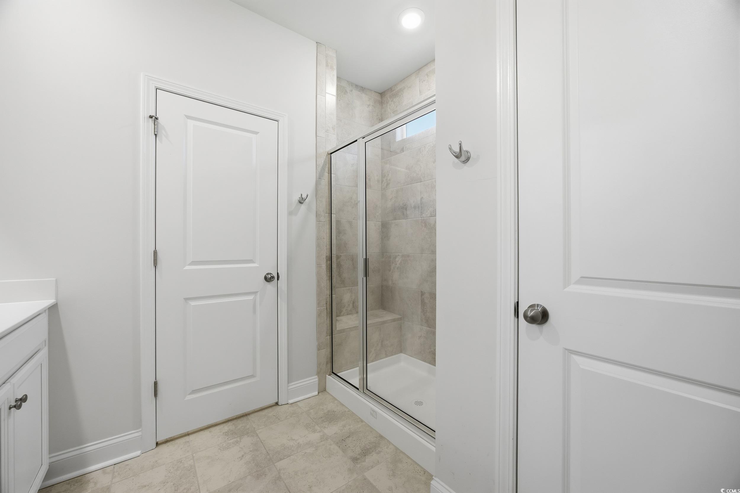 386 Harbison Circle Myrtle Beach, SC 29579 - Photo 21 of 34 Full bath featuring vanity, a shower stall, and light tile patterned flooring