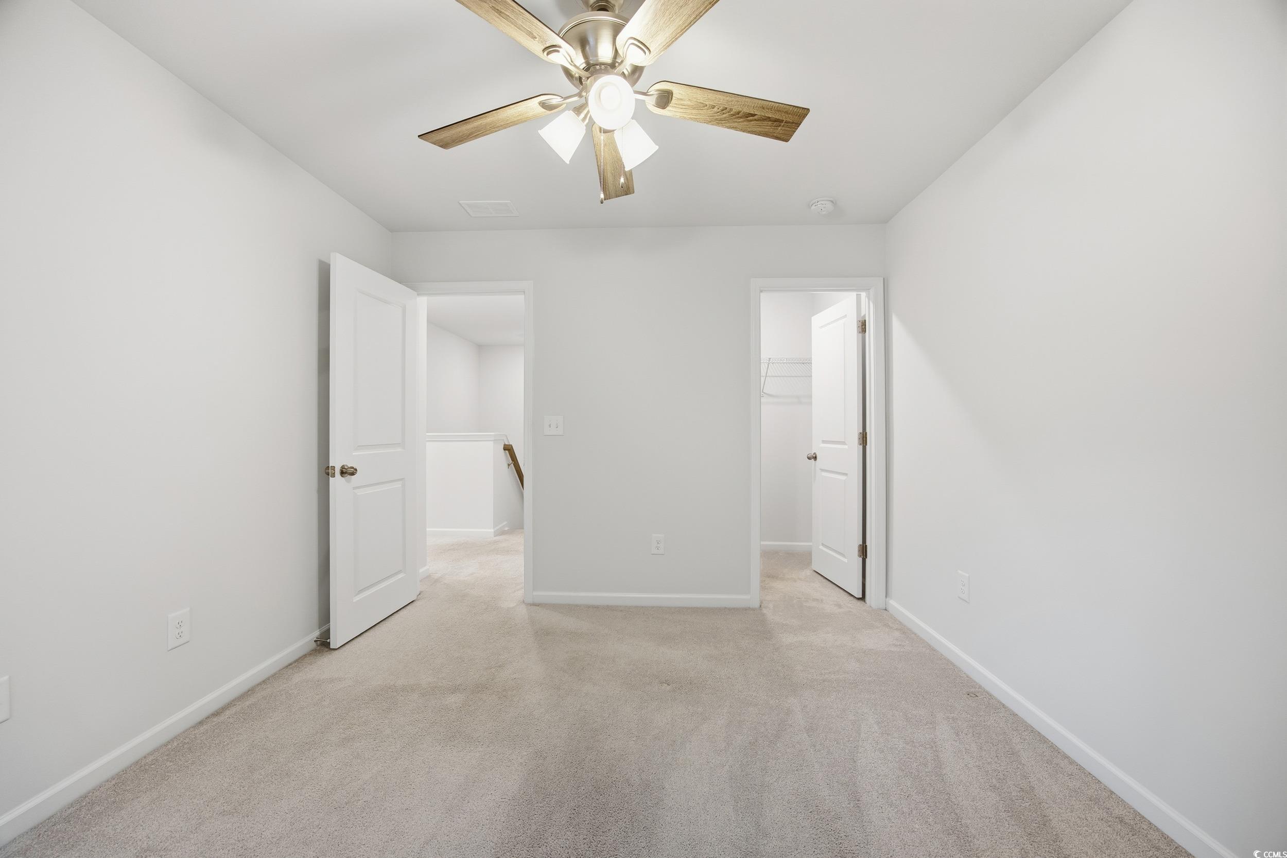 386 Harbison Circle Myrtle Beach, SC 29579 - Photo 23 of 34 Unfurnished bedroom with a spacious closet, light colored carpet, and ceiling fan