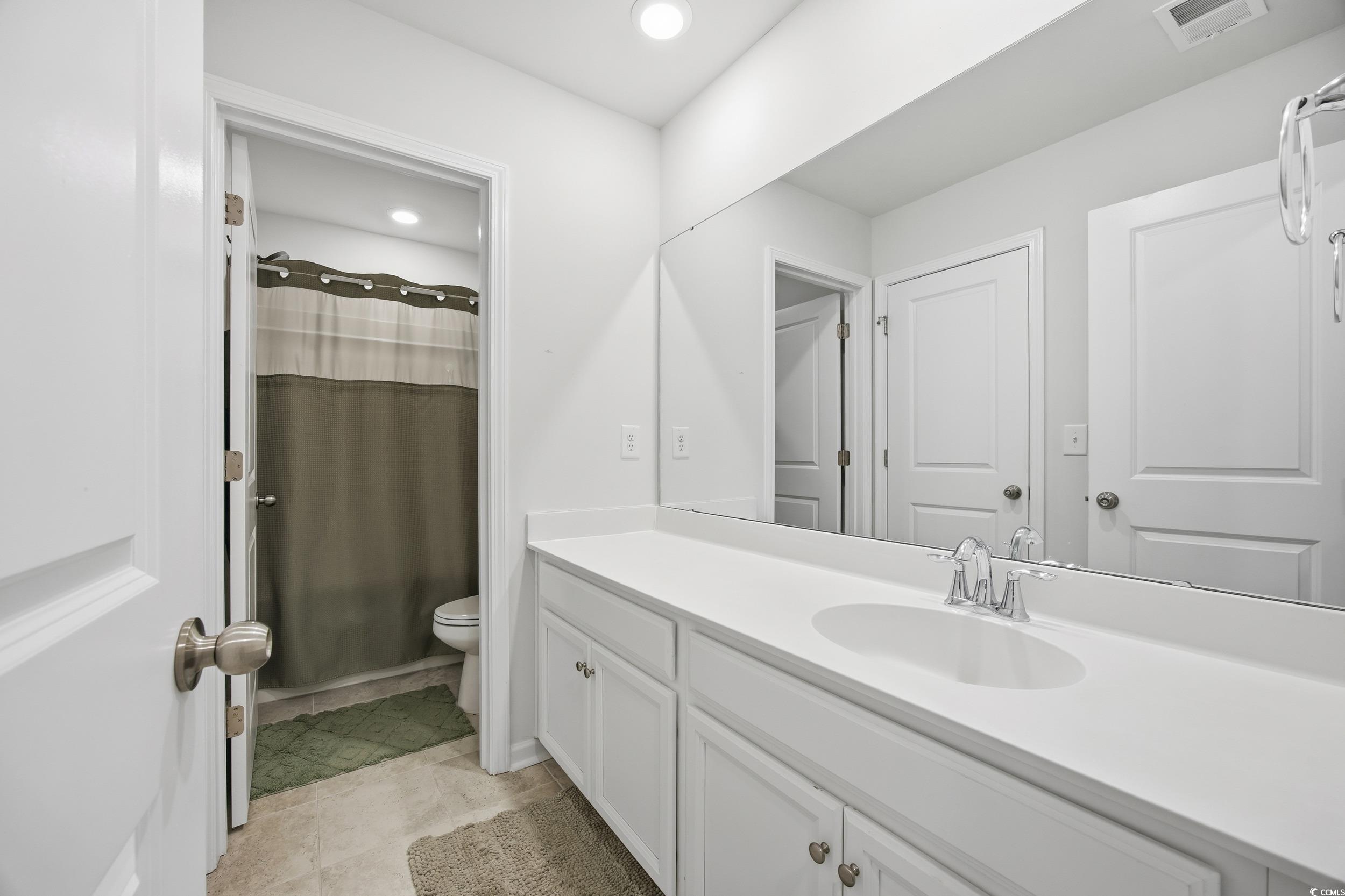 386 Harbison Circle Myrtle Beach, SC 29579 - Photo 26 of 34 Bathroom featuring curtained shower, vanity, light tile patterned floors, and recessed lighting