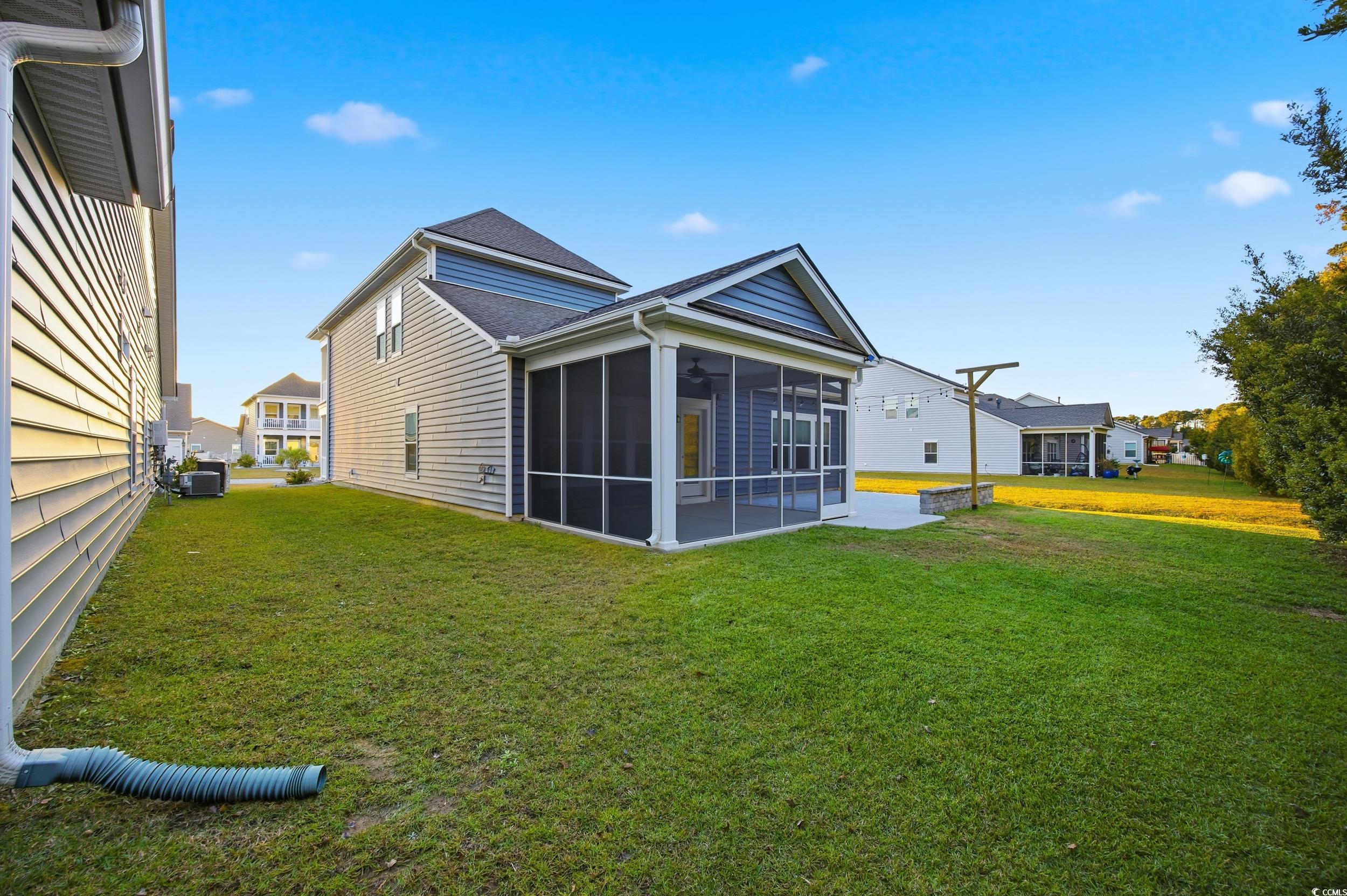 386 Harbison Circle Myrtle Beach, SC 29579 - Photo 36 of 40 Rear view of property featuring a yard and a sunroom