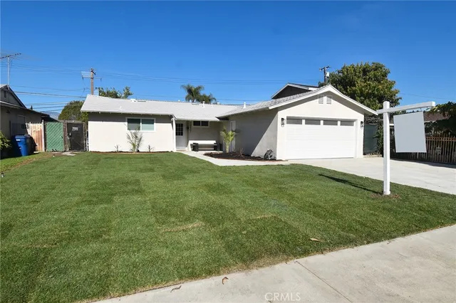 a view of a house with a yard and garage