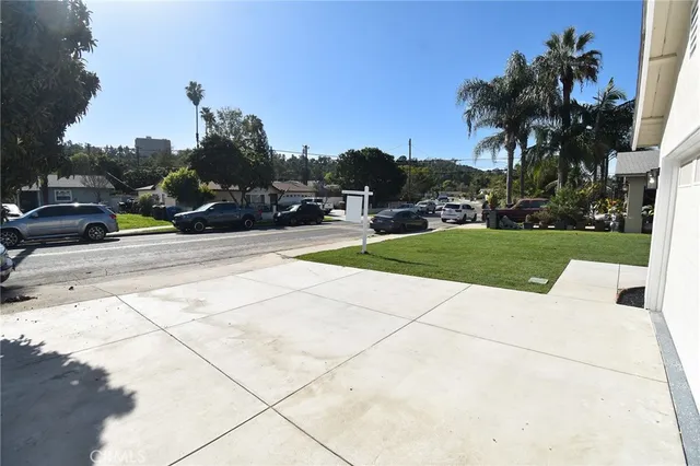 a view of a yard with cars parked