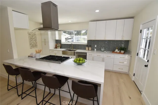 a kitchen with a sink a stove cabinets and counter space