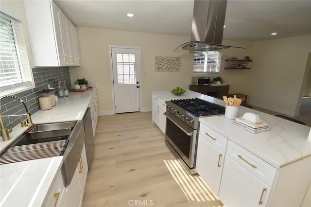 a kitchen with a sink stove and cabinets