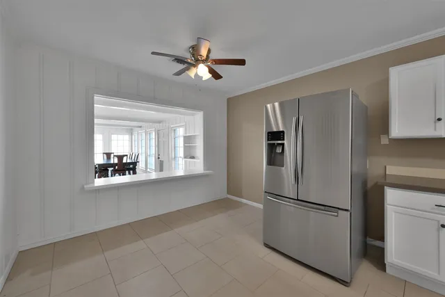 a metallic refrigerator freezer sitting in a kitchen