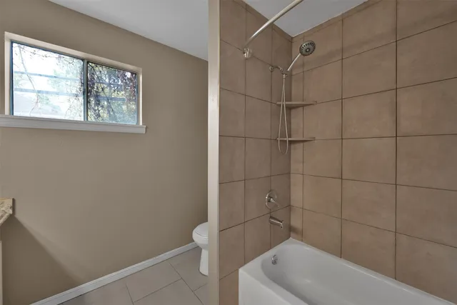 a bathroom with a toilet and bathtub