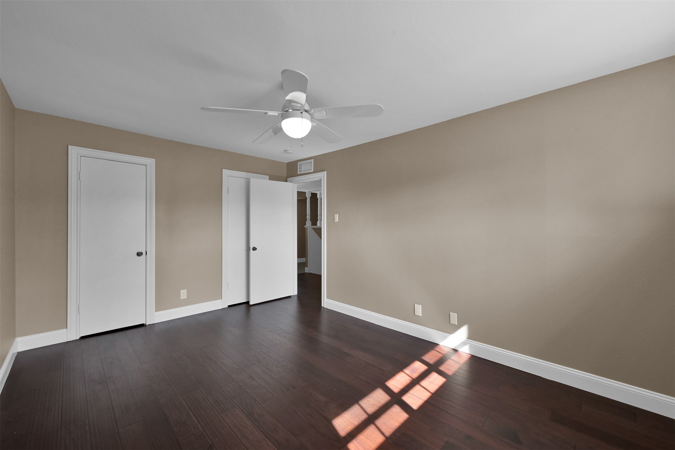 416 Milwaukee Street Houston, TX 77009 - Photo 20 of 25 a view of an empty room with wooden floor and a window