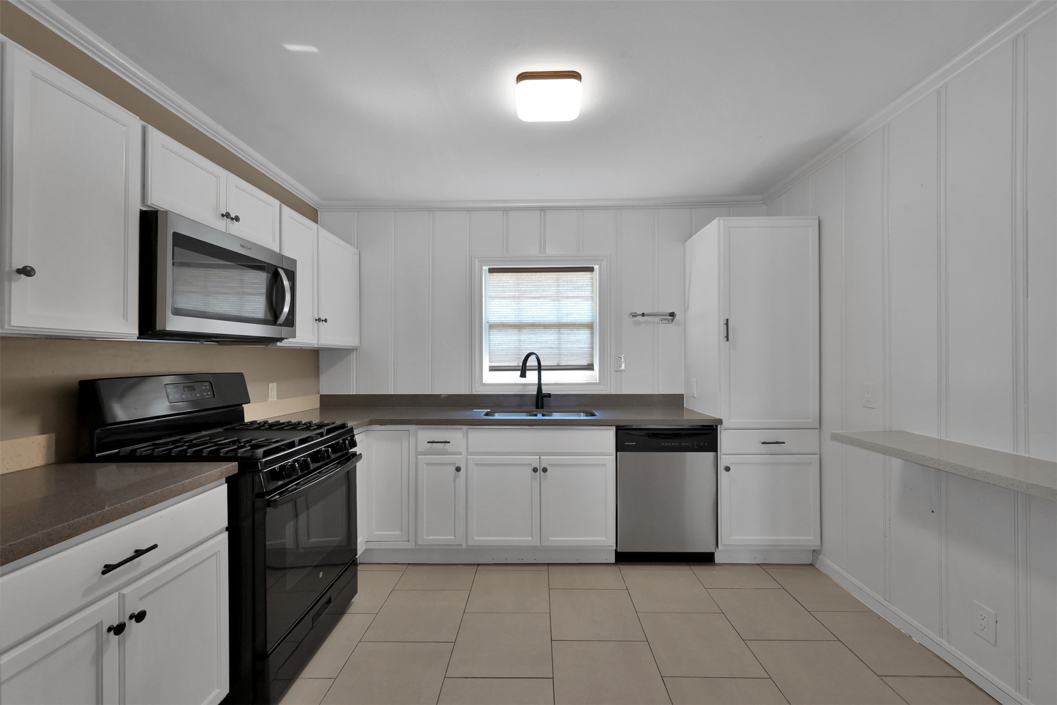 416 Milwaukee Street Houston, TX 77009 - Photo 9 of 25 a kitchen with a sink a stove and cabinets