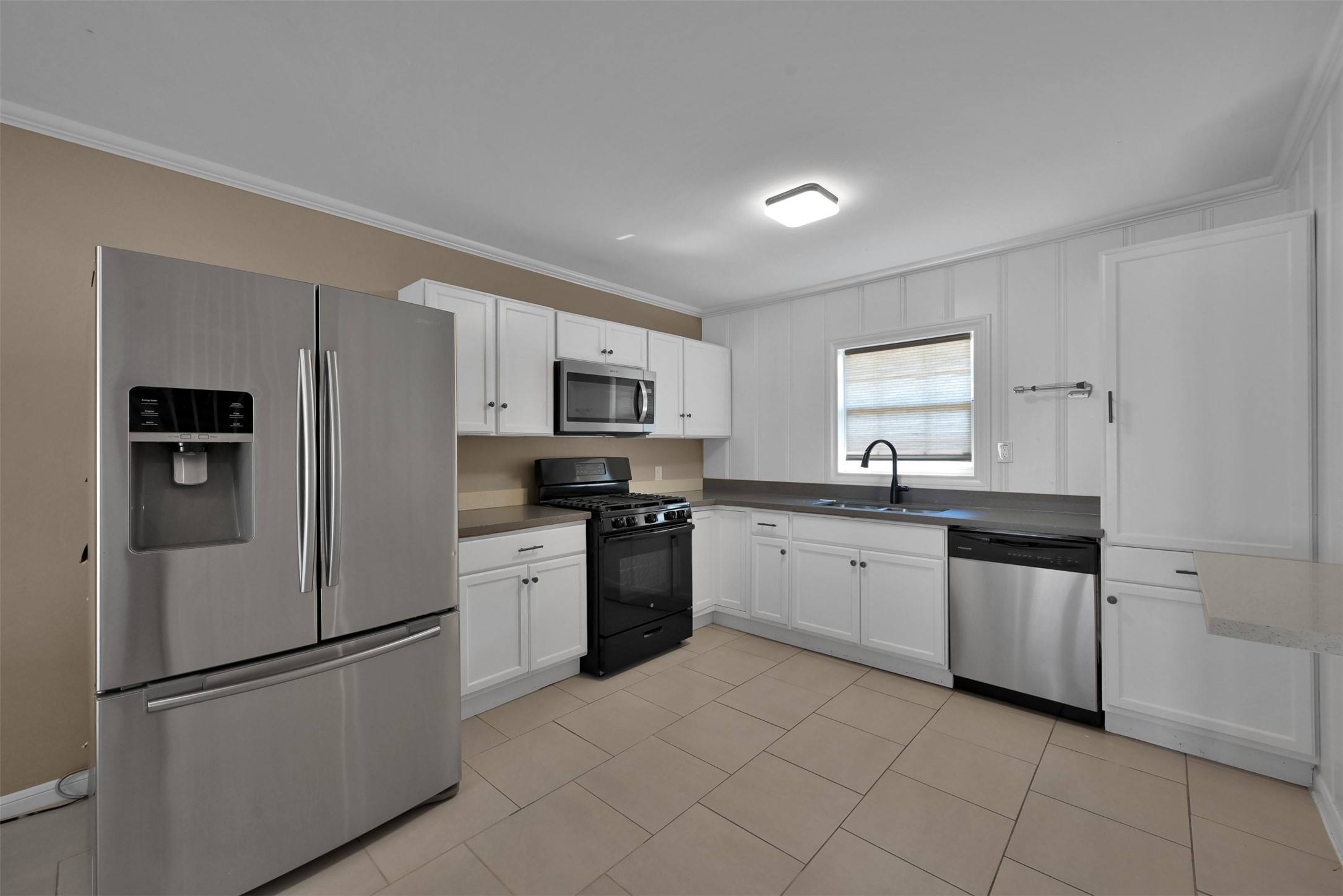 416 Milwaukee Street Houston, TX 77009 - Photo 10 of 25 a kitchen with white cabinets stainless steel appliances and sink