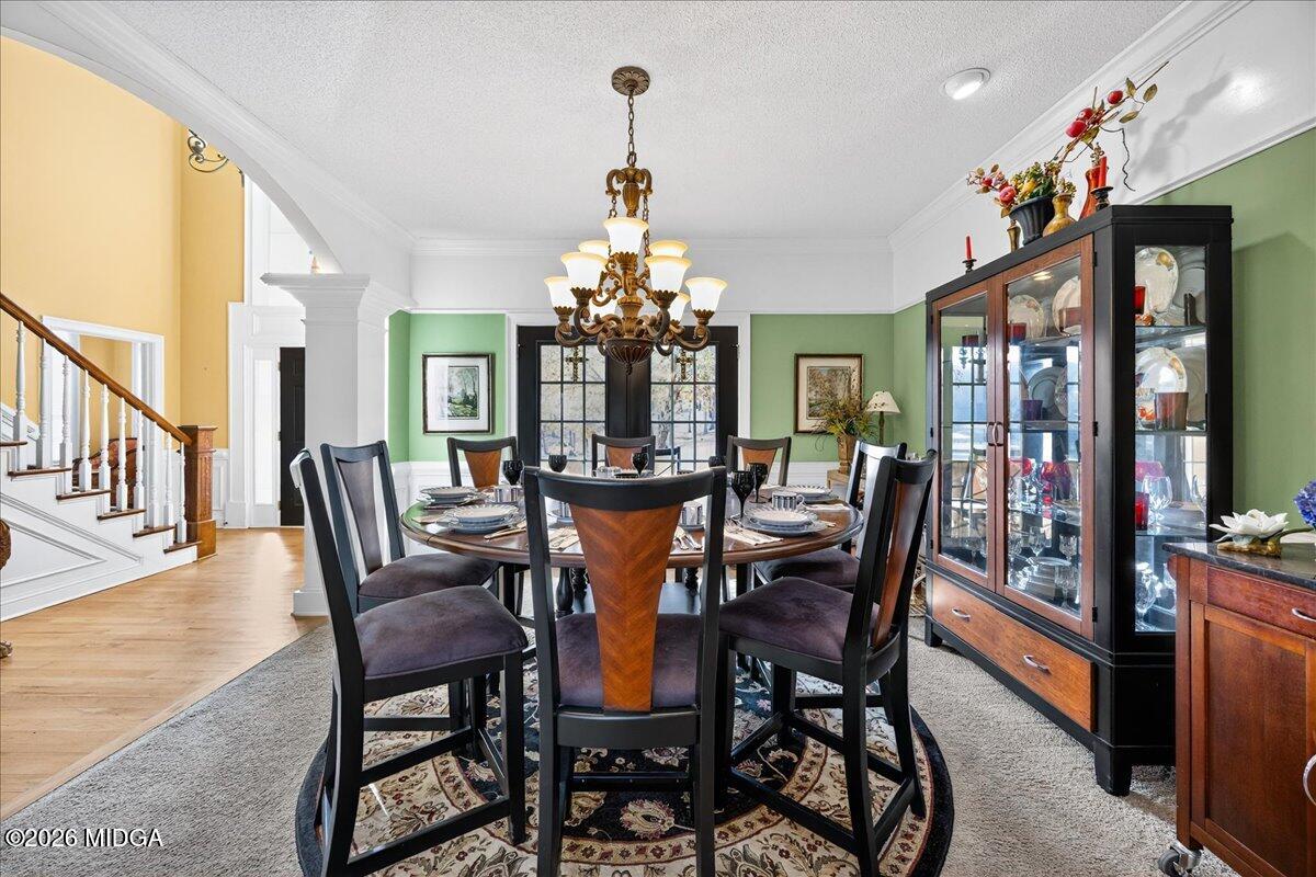 518 River Overlook Forsyth, GA 31029 - Photo 5 of 96 a dining room with furniture a chandelier and wooden floor