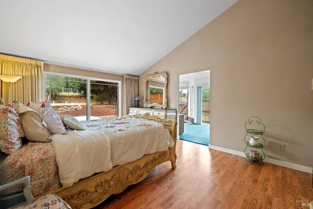 a large white kitchen with granite countertop a large window and a sink