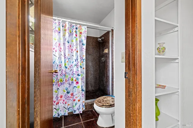 a bedroom with a bed and a flat tv screen on dresser