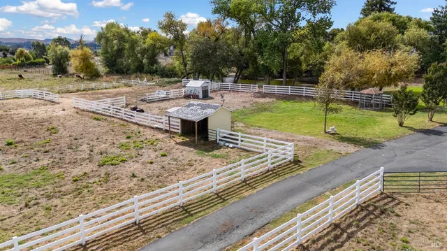 an aerial view of a house with a yard