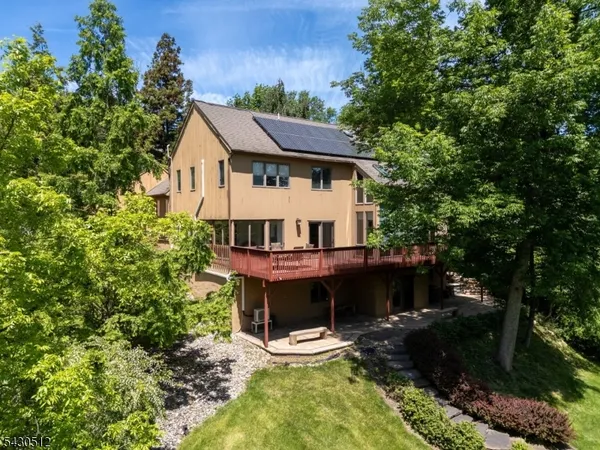 aerial view of a house with a yard balcony and furniture