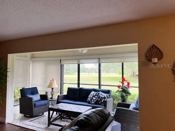 a kitchen with stainless steel appliances kitchen island granite countertop a stove top oven a sink a dining table and chairs with wooden floor